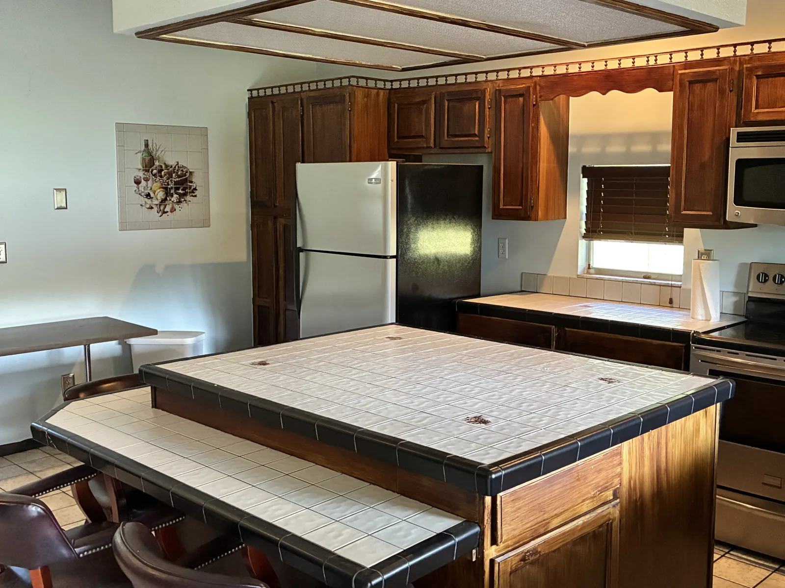 Stone-topped kitchen island and dining area in the Leesburg Live-Work Estate